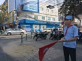 A Cambodian Red Cross CRC young male volunteer holding a flag promotes health care on the street