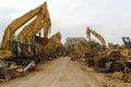 Construction site with parked rows of excavator machines in a row