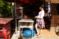 Girl in a local Khmer restaurant. Waitress cooking dried meat.