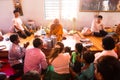 Image of people in buddhist temple paying respect to monks. Religious celebration. Royalty Free Stock Photo