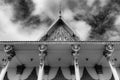 Phnom Penh Cambodian Royal Palace - looking up at statues in roof detailing - stark black and white