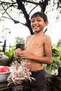 Image of a Khmer rural young man in the countryside. Fresh frog/toad