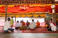 Image of people in buddhist temple paying respect to monks. Religious celebration. People serving rice to monks. Royalty Free Stock Photo