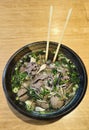 Pho Beef, Chicken Beef Meatballs RAMEN Traditional Vietnamese noodle soup with herbs in a bowl with chopsticks Royalty Free Stock Photo