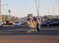 Two men walking with cart full of groceries on supermarket parking lot