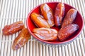 Phoenix fruit in red bowl on bamboo mat