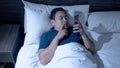 Phone Addicted, Man Using Smart Phone on Bed at Midnight