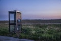 Phone box on rural landscape at sunset Royalty Free Stock Photo