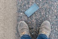 Phone with broken screen on asphalt