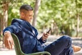 Phone, business man and typing at park, social media or internet browsing. Relax break, mobile tech and male employee Royalty Free Stock Photo