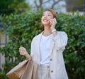 Phone call, Asian woman and retail shopping bag of a gen z person with mobile outdoor. Happy, communication and Royalty Free Stock Photo