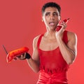 Phone call, beauty and gay man talking with a sassy attitude and red outfit in a studio. Conversation, mobile and Royalty Free Stock Photo