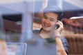 Phone call, cafe window and Asian man in networking conversation with laptop, smile and online meeting. Happy tech Royalty Free Stock Photo