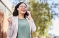 Phone call, celebration and businesswoman with good news in the city walking in the street. Success, happy and Royalty Free Stock Photo