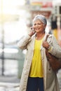 Phone call conversation, walking and elderly woman talking on cellphone discussion, communication or chat. Sidewalk Royalty Free Stock Photo