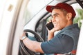 Phone call, delivery and courier talking on a mobile, working and driving for ecommerce business in a car. Young, happy Royalty Free Stock Photo