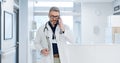 Phone call, doctor and man walking in hospital, talking or conversation for healthcare. Smartphone, smile and medical Royalty Free Stock Photo