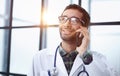 Shot of a male doctor talking on a mobile phone during a hospital Royalty Free Stock Photo