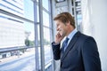 Phone call, office and business man by window in discussion, talking and conversation in lobby. Corporate worker Royalty Free Stock Photo