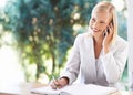 Phone call, receptionist and woman taking notes at reception, writing and talking to contact. Smile, notebook and female