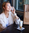 Phone call, shopping bag and Asian woman in cafe with coffee talking, chatting and social conversation. Communication Royalty Free Stock Photo