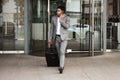 Phone call, travel and luggage with a business man walking in the city for an international trip. Mobile, communication Royalty Free Stock Photo