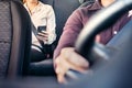 Phone in car or taxi. Passenger woman using cellphone in back seat of cab. Driver and customer. Rideshare mobile app. Royalty Free Stock Photo