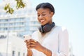 Phone, city and music with a business black woman typing a text message while walking to work outdoor. Mobile Royalty Free Stock Photo