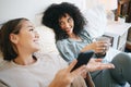 Phone, coffee and lesbian couple on bed in conversation for bonding, relaxing and resting together. Happy, communication Royalty Free Stock Photo