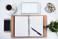 Phone, digital tablet, clock, plant, memo pad and blank notebook with on white flat lay. Royalty Free Stock Photo