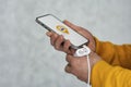 Phone display with Taxi icon on light background. Man holds a mockup smartphone in his hand close-up