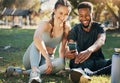 Phone, earphones and couple on an outdoor exercise while watching funny video on social media. Fitness, sport and Royalty Free Stock Photo