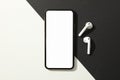 Phone with empty screen and headphones on black - white background Royalty Free Stock Photo