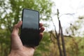 Phone in hand search for communication in the forest