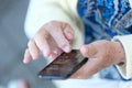 Phone in the hands of an elderly woman Royalty Free Stock Photo