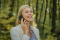 Phone happy outdoor. Blonde woman rejoicing and holding mobile phone in hands. Happy woman using smart phone. Work goals Royalty Free Stock Photo