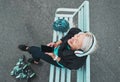 Phone, happy and woman roller skating with music for training, exercise and fun on a city bench. Laughing, mobile and Royalty Free Stock Photo