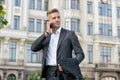Phone keeps him connected. Businessman talk on mobile phone. Handsome man with cell phone outdoor. Phone for