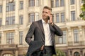 Phone keeps him connected. Businessman talk on mobile phone. Handsome man with cell phone outdoor. Phone for