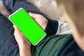 Phone a for keying is holding kid. Smartphone with a green screen in hand child. Royalty Free Stock Photo