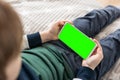 Phone a for keying is holding kid. Smartphone with a green screen in hand child Royalty Free Stock Photo