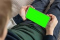 Phone a for keying is holding kid. Smartphone with a green screen in hand child Royalty Free Stock Photo