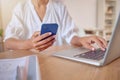 Phone, laptop and search with hands of woman in office for social media, networking and connection. Internet, technology