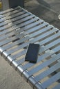Phone left on a public bench.lost smart phone concept Royalty Free Stock Photo