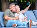 Phone, love and old couple take a selfie on holiday vacation in Amsterdam for bonding while drinking wine. Retirement