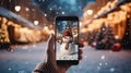 phone in man hand making photo of festive colorful Christmas tree and snowman in winter snowy city Royalty Free Stock Photo