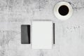 Phone notepad with pencil and coffee on a flat masonry. View from above Royalty Free Stock Photo