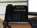 Top view of phone in office keyboard and monitor detail in the background with vintage color tone effect