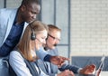 Phone operator working at call centre office helping hiss colleague Royalty Free Stock Photo