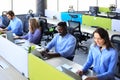 Phone operator working at call centre office helping hiss colleague. Royalty Free Stock Photo